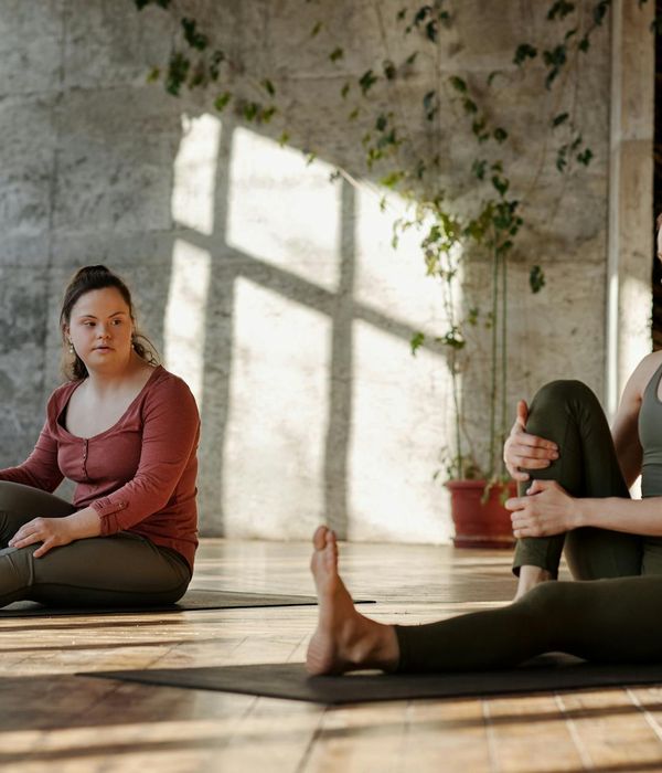 Person stretching gently in a bright, sunlit room, feeling energized.